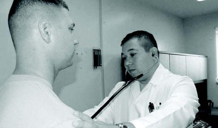 CC-BY CHANEL WEAVER | U.S. ARMY
Capt. David Kassop, U.S. Army,  listens to the heartbeat of a patient in a Maryland clinic. Many who would qualify for subsidies to buy health insurance from healthcare.gov must also qualify for Medicaid — ruling out a significant number of UTD students.