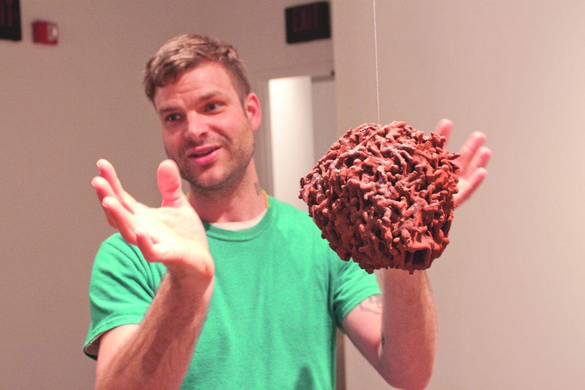 Connie Cheng
Graduate student Val Curry explains the environmental themes he’s incorporated into “Universe,” his art installation currently showing at the McKinney Avenue Contemporary. The exhibit will run until May 3, and Curry will hold a discussion on the work April 2 at 6 p.m.