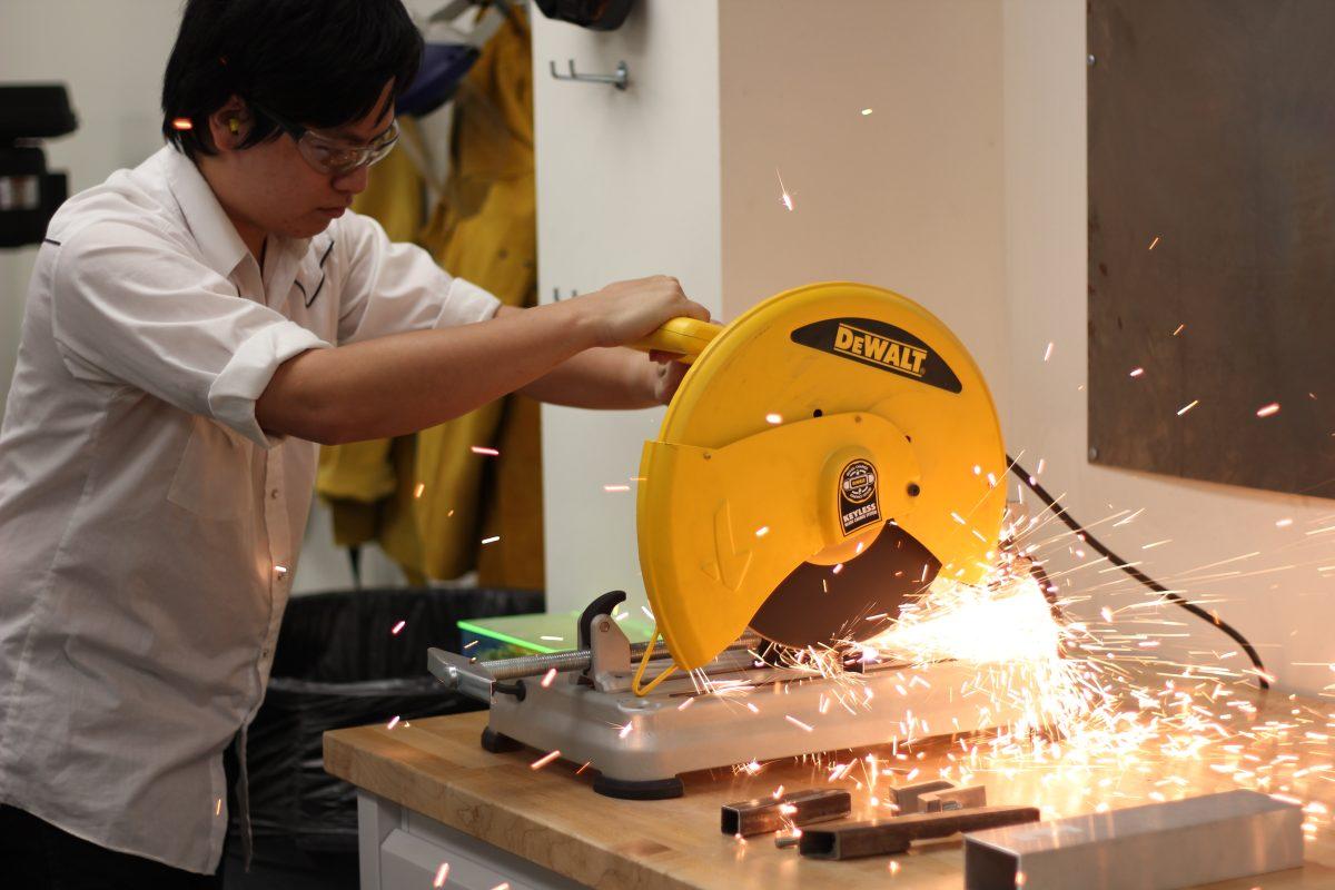 Arun Prasath| Staff
Jonathan Lin uses an electric saw to build a project in the Makerspace room at Synergy Park North. The group was created to encourage students of any major to make crafts using high-tech tools, including a 3-D printer for campus use.