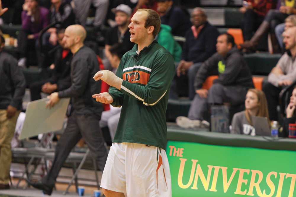 Senior guard Nolan Harvey cheers on his team from the sidelines during the Senior Day game against Concordia on Feb. 21.