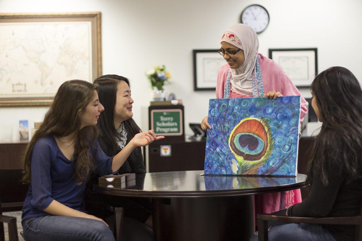 Connie Cheng|Photo Editor
Art UTD president and biology senior Khadijah Mazhar shows other officers one of her paintings. 