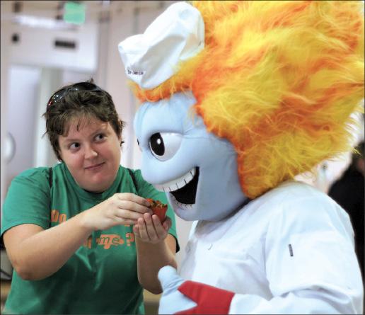 Albert Ramirez| Staff
Sociology senior Melissa Kenfield feeds Temoc during the Dinning Hall opening Aug. 12.