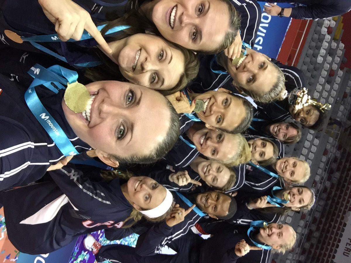 Head volleyball coach Marci Sanders (bottom center) poses with members of the U.S. Women’s National Volleyball team in Peru after its first-place finish at the Pan American Cup on June 21.