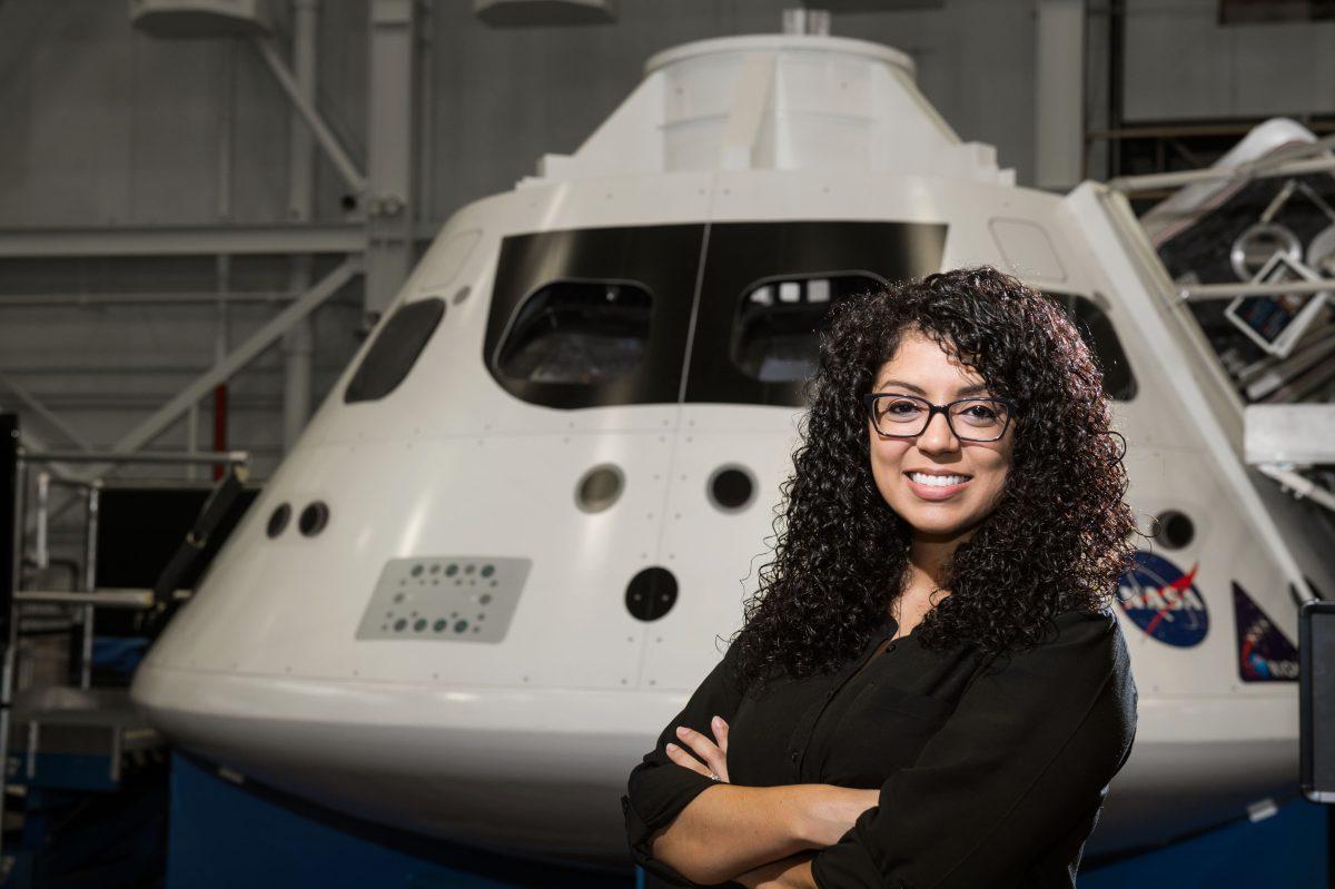 PHOTO DATE: 07-27-15
LOCATION: Bldg. 9NW - Orion Mockup Floor
SUBJECT:  Portrait of Christina Deoja in front of Orion medium fidelity mockup for news article from my alma mater (University of Texas at Dallas).
PHOTOGRAPHER: BILL STAFFORD