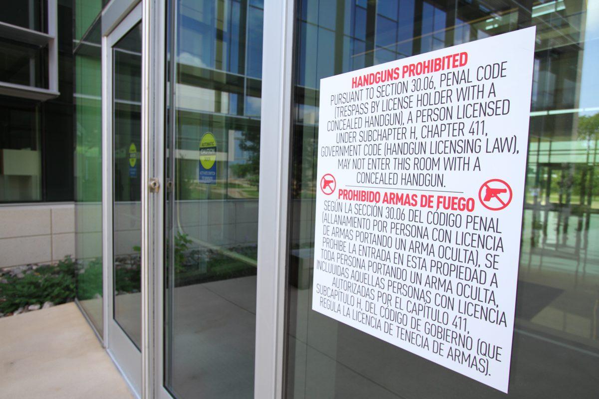 Vinyl signs near entrances to exclusion zones prohibit concealed carry. (Andrew Gallegos | Photo Editor)