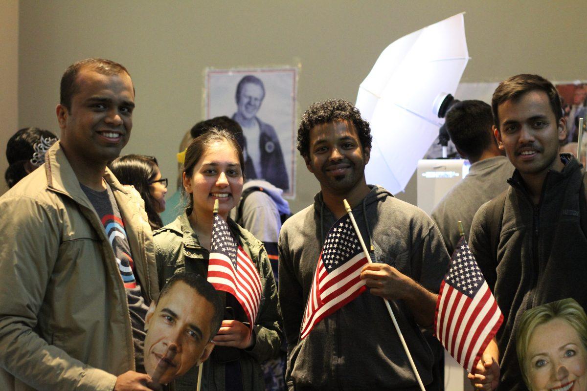 Business graduate student Suyash Shetty (left), psychology junior Maryam Jafri, systems engineering graduate student Amit Singalwar and mechanical engineering graduate student Aniket Joshi participate in election festivities at SG and SUAAB's Political Party on Nov. 8 in the Galaxy Rooms. Photo by Roman Soriano | Mercury Staff.