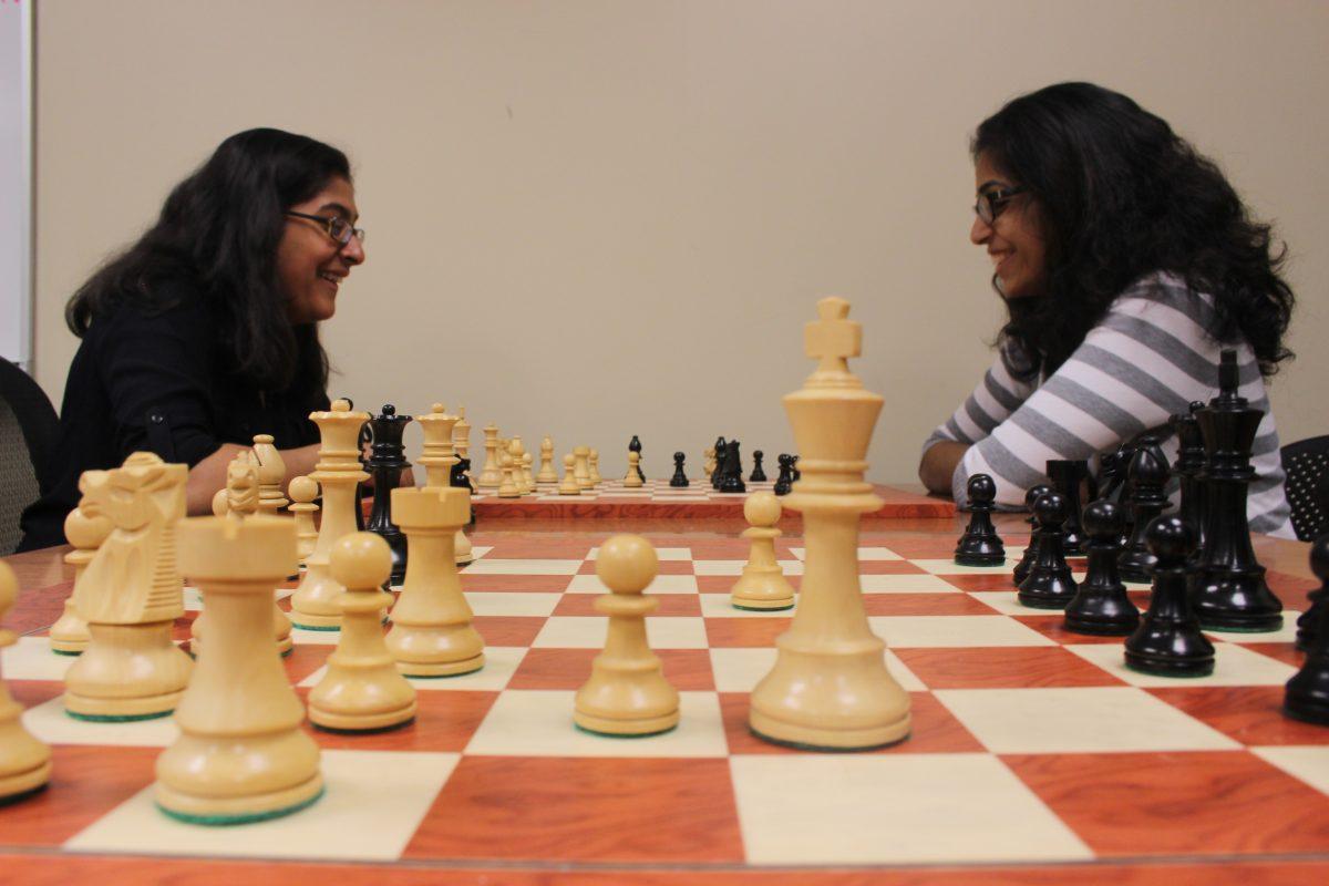 ITS junior Suhasini Sundar (left) and finance senior Alekhya Nandula (right) face off in a chess match. Photo by Ruth Varghese | Mercury Staff.