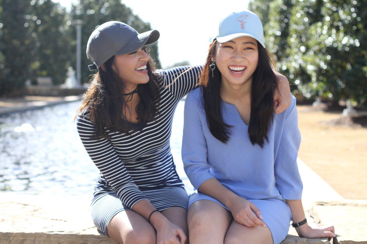 Sophomores Sanya Lakhani (left) and Grace Nguyen sport hats made by Mai. All proceeds from sales go directly to help educate less fortunate children in Vietnam. Photo by Saher Aqeel | Photo Editor.
