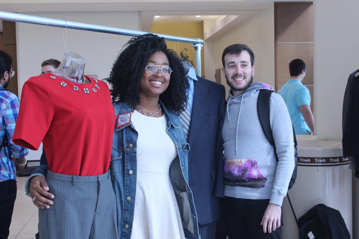 Munashe Chando, biology and business administration senior, and Christian Kelly, supply chain management graduate student, stand next to the mannequins they dressed for "Mannequin Monday" during the first day of the Comet Closet Launch Week. Ruth Varghese | Mercury Staff.