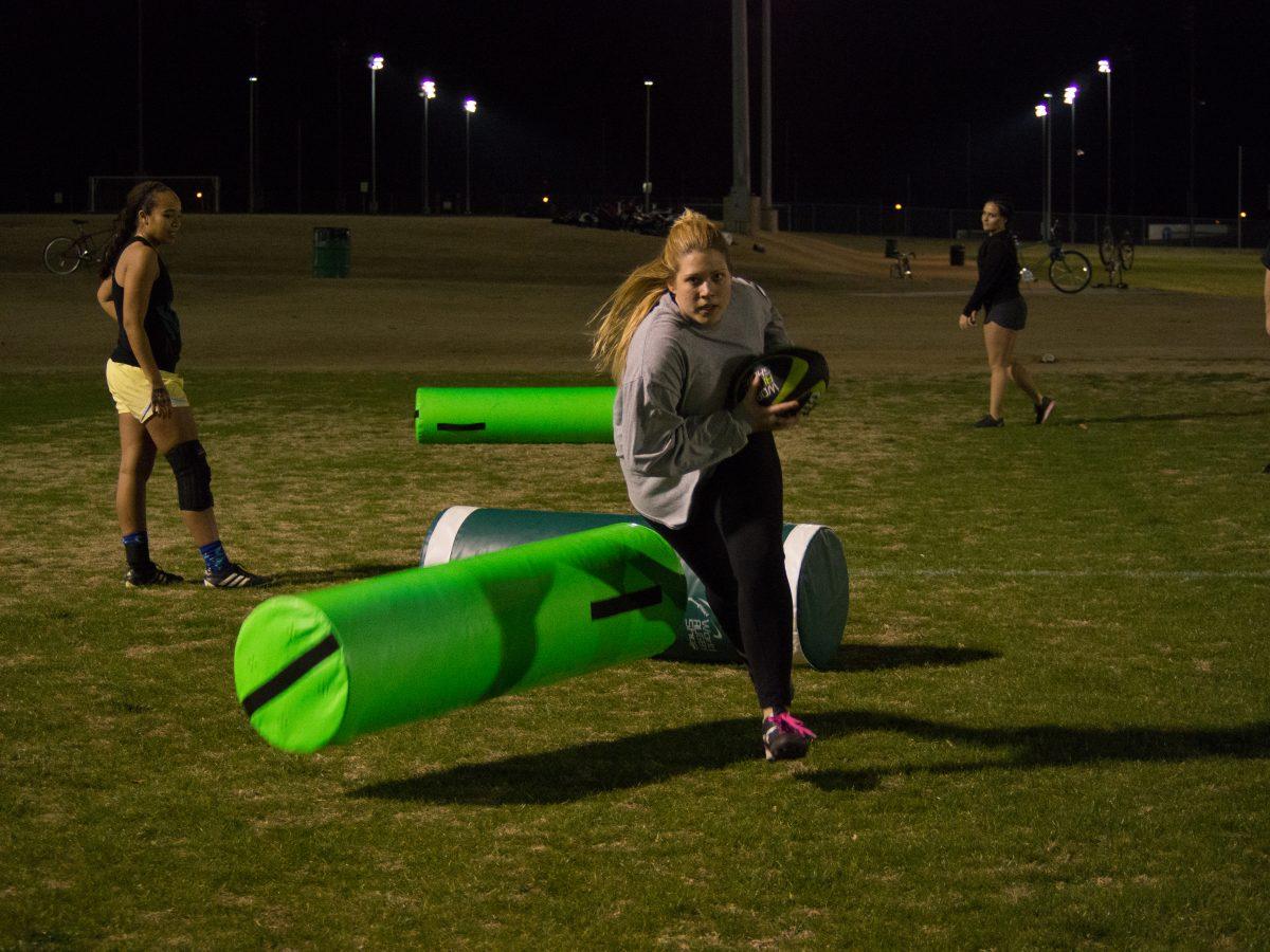 Rugby player Kaitlyn Stacey practices with the rugby team at night on Jan. 31. Practices are held at the UTD soccer fields. Difficulties with finding new recruits and retaining players due to graduation have plagued the team, but it has still increased in size during each of its three seasons on campus. Photo by Roman Soriano | Mercury Staff.