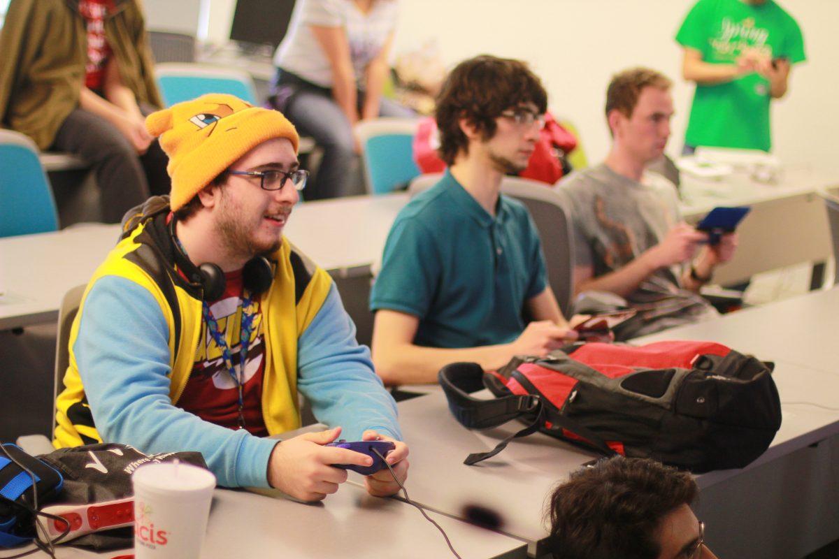 Computer science freshman James Landry (left), computer science senior Andrew Julian (middle) and ATEC senior Tyler Mitchell play a game of Pokemon during a Pokemon League gathering. The group holds tournaments once a month. Photo by Deepak Godavarthi | Mercury Staff.