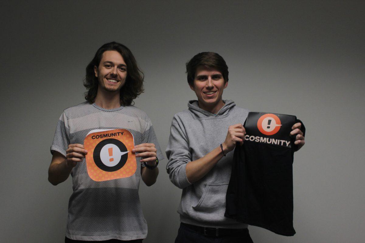 Software engineering junior Zac Cooner (left) and software engeering senior Chance Hudson showcase Cosmunity merchandise. Photo by Ruth Varghese | Mercury Staff.