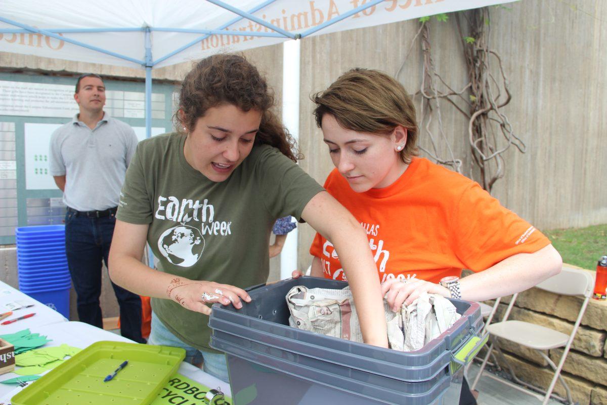 International political economy sophomore Emily Stinnett (left) and emerging media and communications sophomore Delaney Conroy showcase worm composting bins. Photo by Ruth Varghese | Mercury Staff.