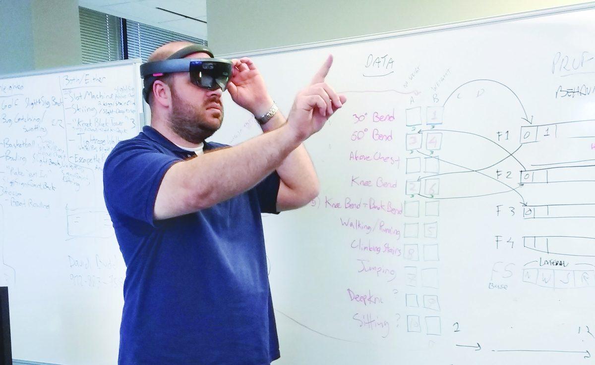 Computer programmer Leonard Evans uses the HoloLens to demonstrate the Emotive Virtual Reality Patient System. Photo by Ruth Varghese | News Editor.