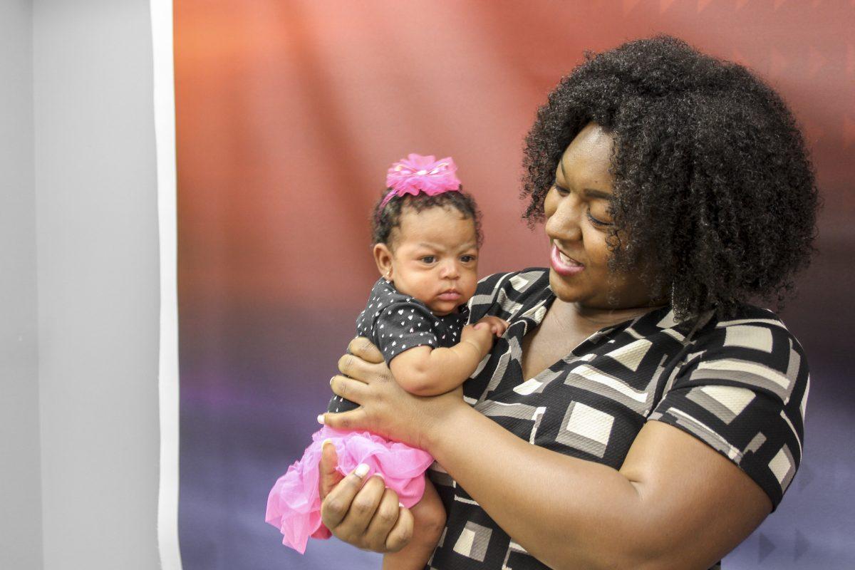  Alumna Jessica Chester holds her six-week-old daughter Ava in her arms as she recalls her time on campus while raising two children. Chester entered UTD with a four-month-old baby boy, unaware she was pregnant with her second child. Photo by Ruth Varghese | News Editor.