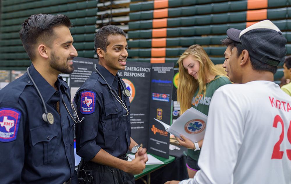 University Emergency Medical Response Chief Umer Nadir (left) and Administrative Lt. Nidhish Lokesh talk with UTD students during an orientation fair where they volunteered as medical responders. Photo courtesy of UTD News Center.