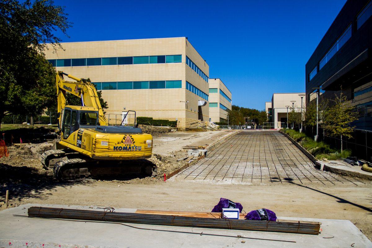 Construction workers prepare the road between the Activity Center, South Engineering and Computer Science building and Student Services Building Addition for an updated road surface. The project should be complete by Nov. 30. Photo by William Legrone | Mercury Staff.