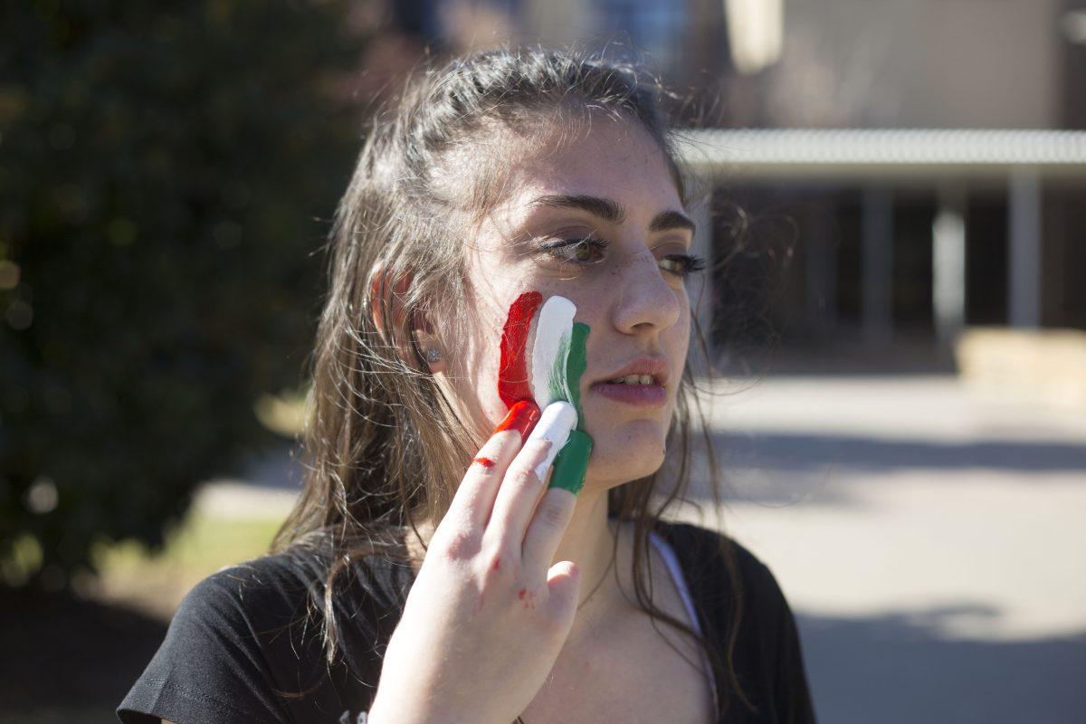 Marketing junior Alaae Nasser wears the colors of the Lebanese national flag. Nasser came up with the idea for her photobook while reflecting on her multicultural background. Photo by Noah Whitehead | Mercury Staff.