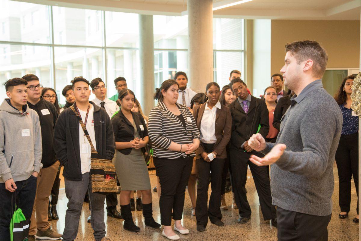 High school students interested in the Jindal Young Scholars program tour Residence Hall West as Residential Life Coordinator Cody Queen (right) shows them the amenitites and the model dorm that UTD has to offer. Photo courtesy of Scott Booth.