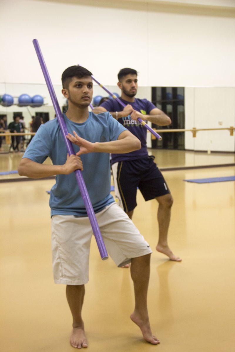Finance sophomore Aneesh Bindingnavile and Information Technology Systems senior Vraj Mehta practice bhangra. Photo by Nadine Omeis | Mercury Staff.