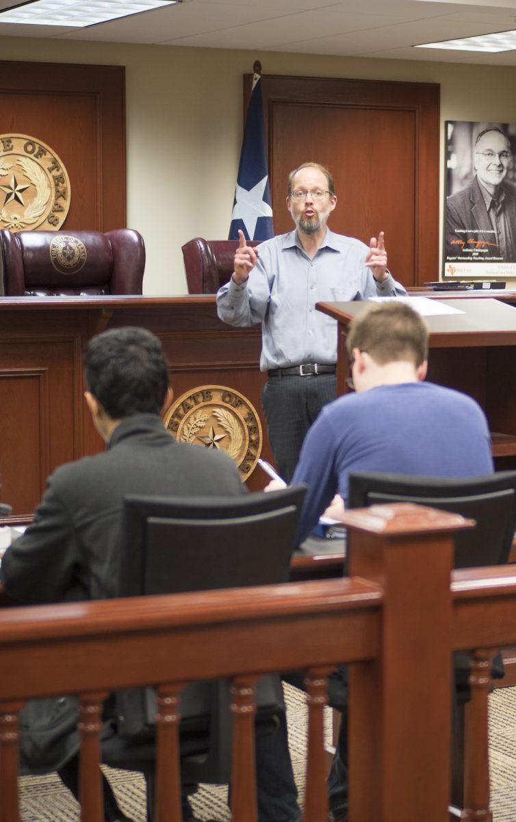 Political science professor Douglas Dow teaches a Moot Court class on Feb. 12. Members of the class learn to form legal arguments and present them to a mock Supreme Court. Former pre-law advisor Anne Dutia continued to coach Moot Court students until mid-December after her resignation. Photo by Anupam Gupta  | Mercury Staff.
