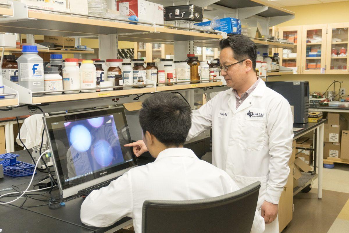 Assistant professor of chemistry, Jiyong Lee, reviews isolated cancer stem cells with a member of his team. Lee’s research focuses on utilizing nanoparticles and lasers to destroy cancer cells. Photo by Anupam Gupta | Mercury Staff.