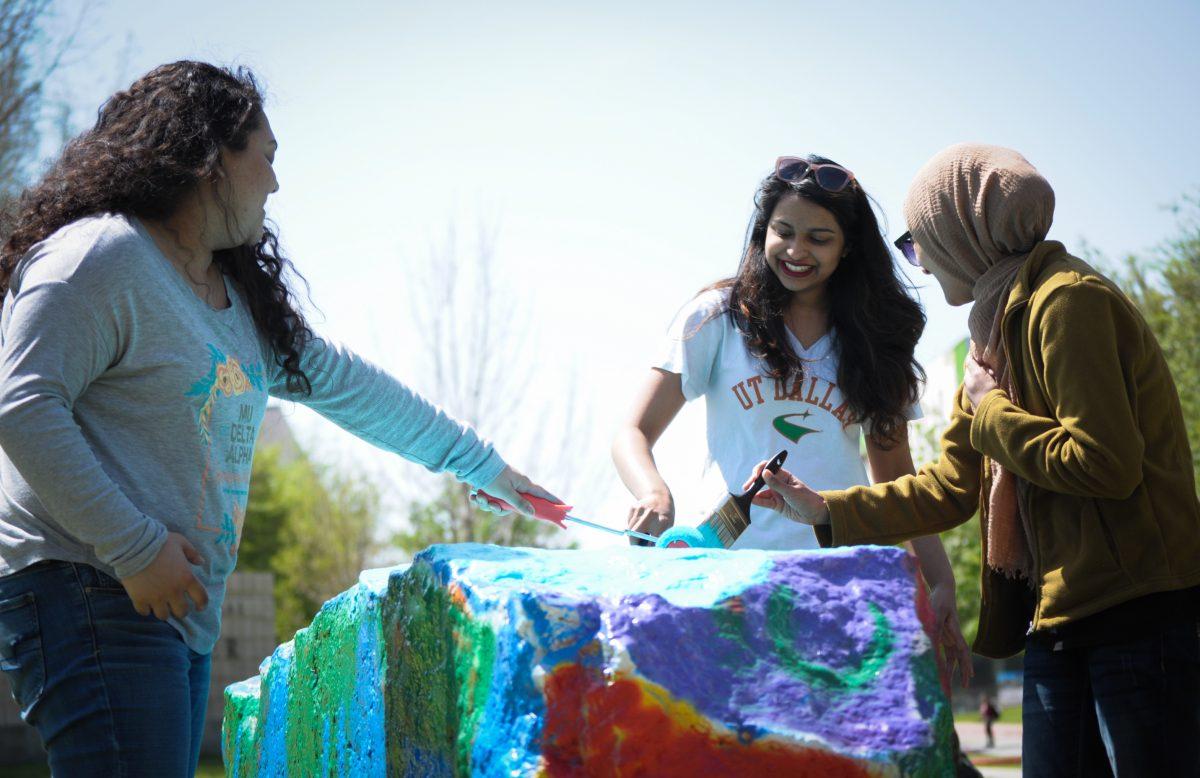 Mu Delta Alpha members paint the Spirit Rocks to spread awareness about sexual assault on April 4. The sorority was first established as a student group before it was converted into a Greek organization in 2017. Photo by Madeline Ambrose | Mercury Staff.