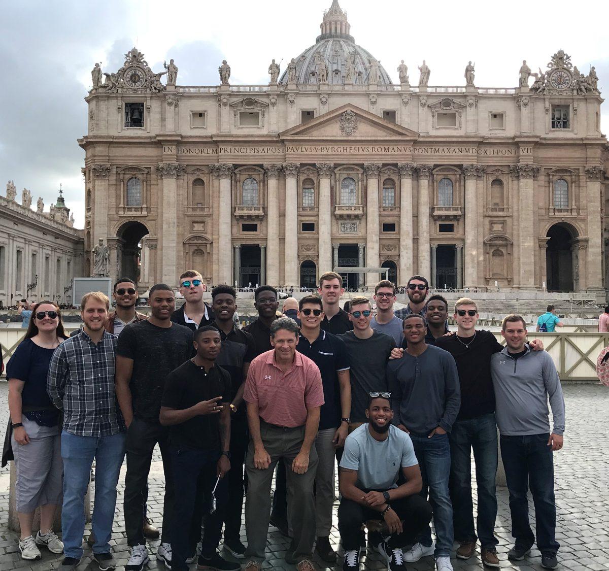The men’s basketball team stands in front of St. Peter’s Basilica in Vatican City. Photo courtesy of UTD Men's Basketball.