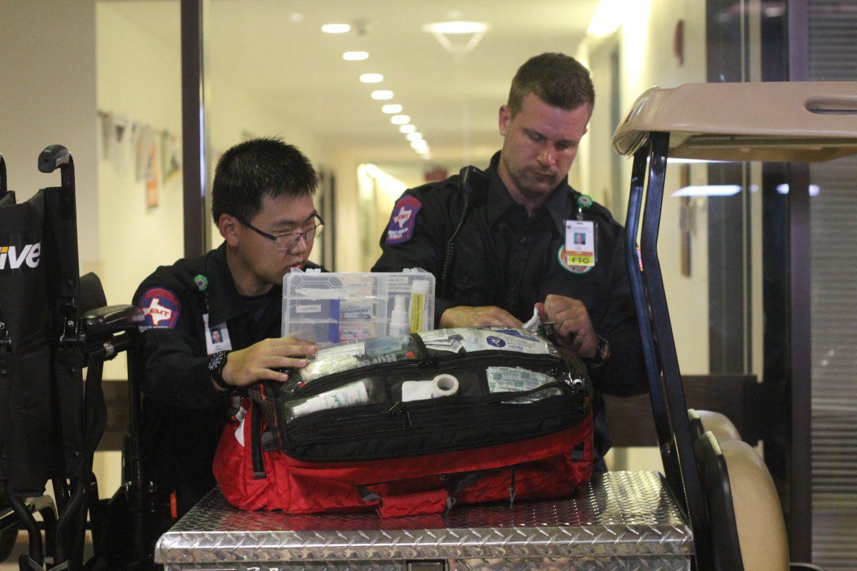 Neuroscience senior Alex Collins and psychology freshman Jack Cheng check the contents of a supply bag at the beginning of their shift. Photo by Michael Stout | Mercury Staff.