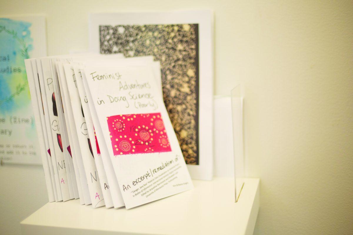 A set of "zines," which are self-published student or faculty works, stand in the new community bookshelf. Photo by Noah Whitehead | Photo Editor.