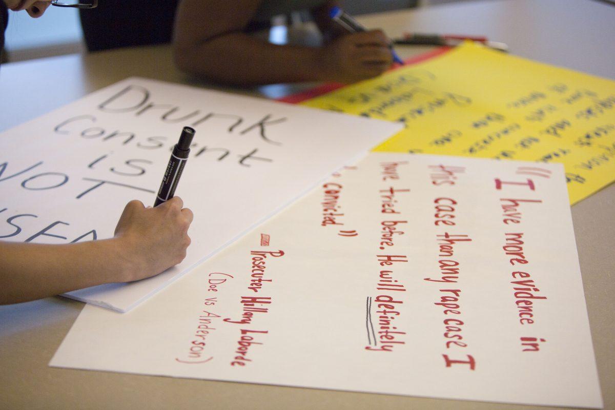 Rose Minjarez, a psychology and child development junior, prepared for Friday’s protest, which will take place on the Plinth. Photo by Megan Zerez | Mercury Staff.