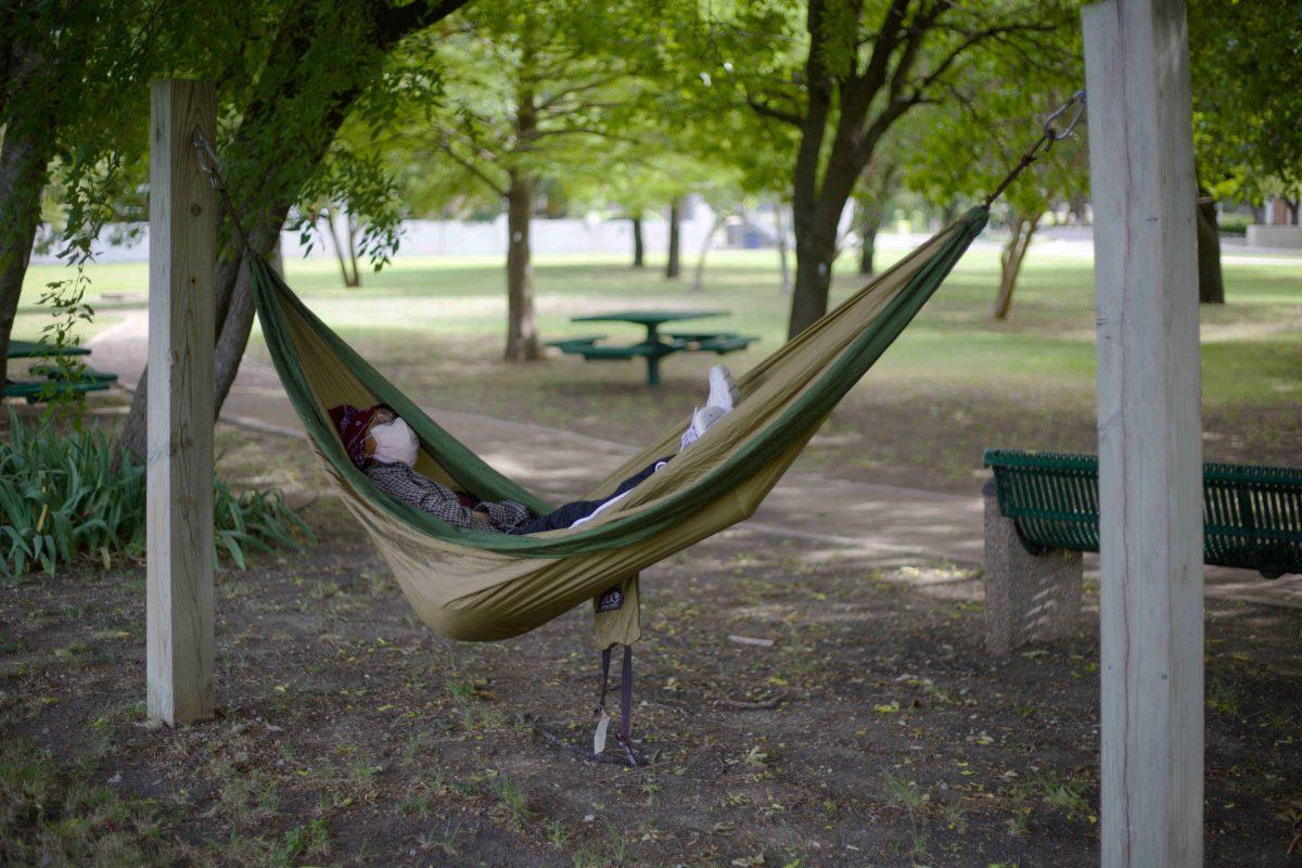 A UTD student takes a summer nap in a hammock near the Gazebo. The Gazebo is one of four areas on campus with stands. Photo by Viet Vu | Photo Editor
