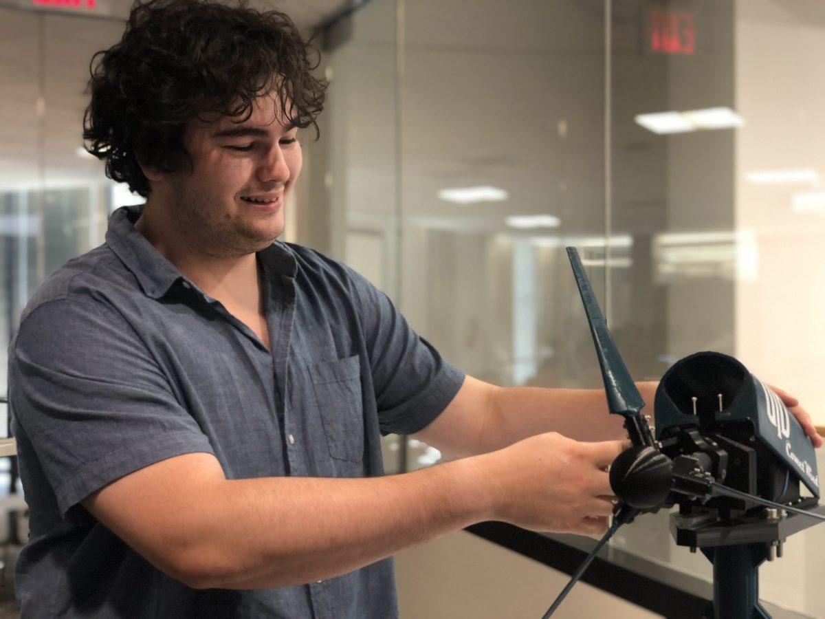 Club founder and senior Fernando Harmjanz demonstrating how a wind turbine uses induction to convert kinetic energy from the blades into electrical energy. Photo By Gregory Binu | Mercury Staff