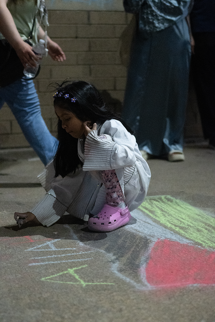 Alex Lawless | CourtesyYoung activist makes chalk drawing in support of detainees at Collin County Jail